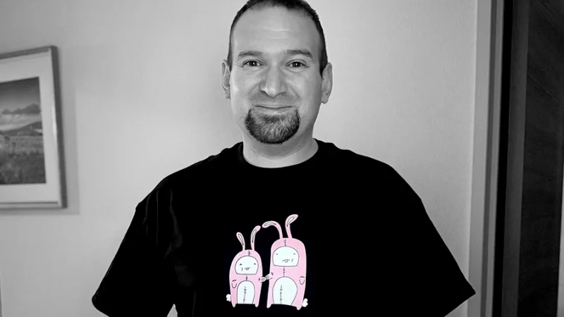 Jeremy wearing a shirt he designed and smiling at the camera
