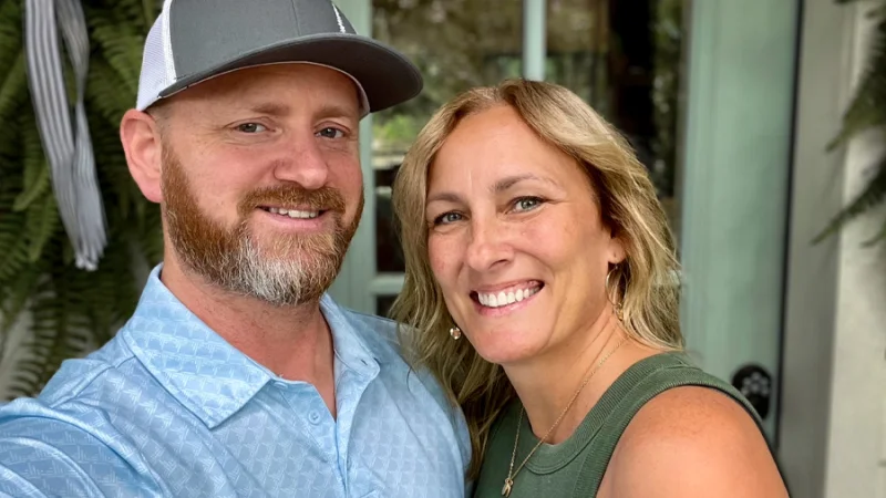 Ken Stout and his wife smile at the camera