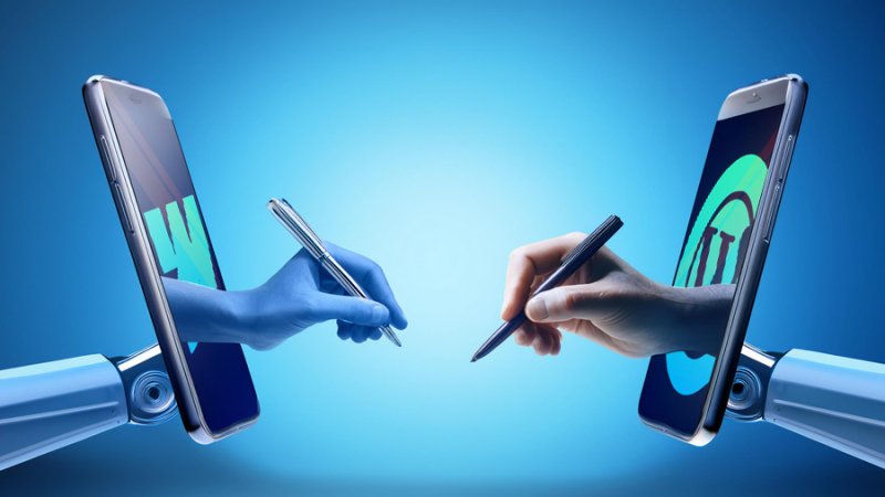 mechanical arms raising two mobile phones that reveal hands holding pens